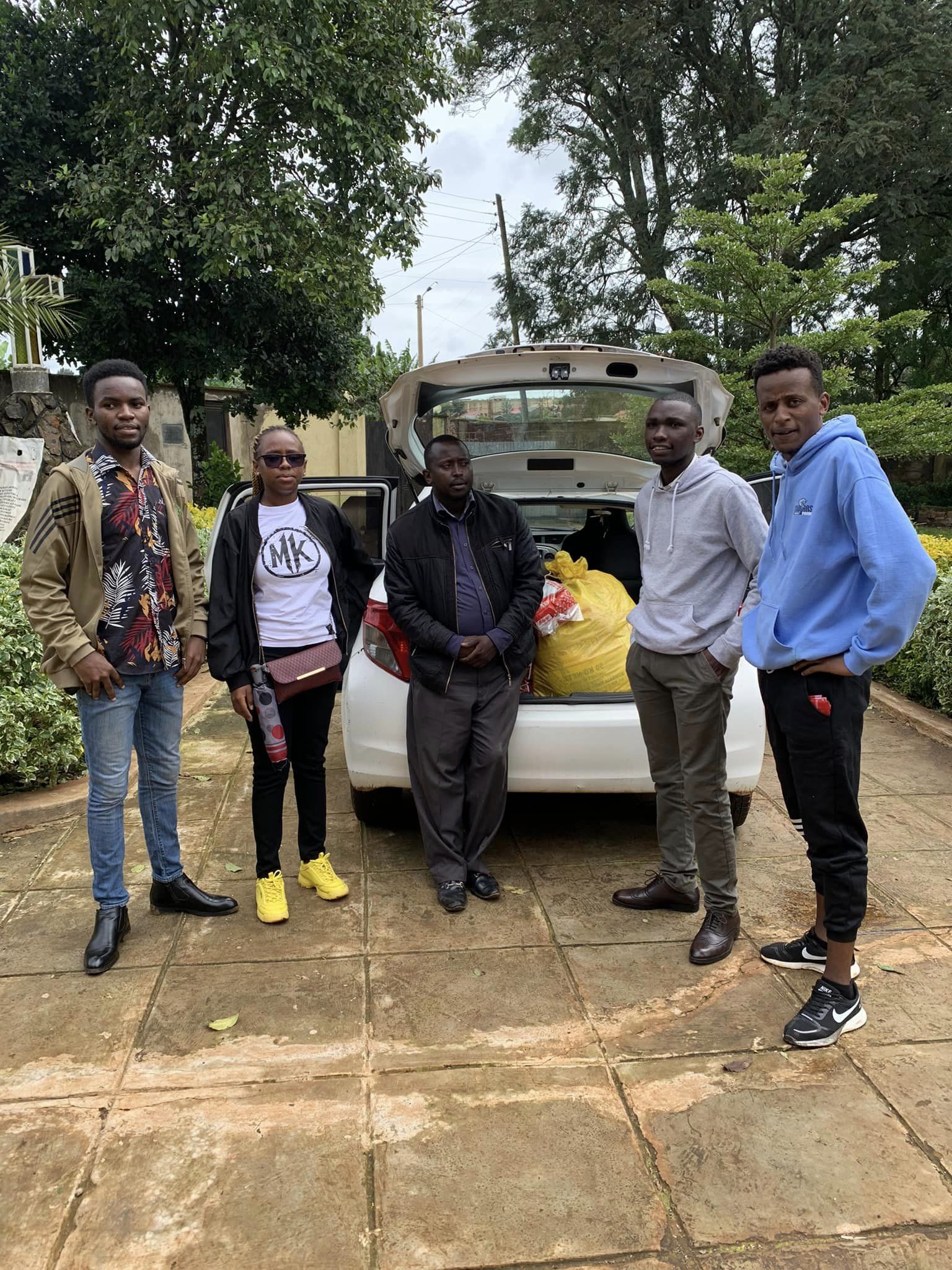 May be an image of 5 people, people smiling, car and road